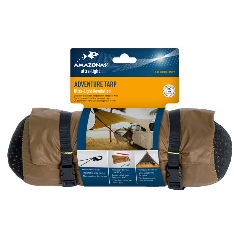 The packaging of the Amazonas Adventure Ultra-Light Tarp features an image of the tarp seamlessly installed next to a vehicle. Emphasizing its robust Nylon Ripstop material, it assures durability and comes with straps and carabiners for hassle-free setup, making it perfect for any adventure.