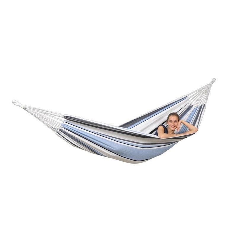 A person enjoying a moment of relaxation in the Apollo & Marine Hammock Set by Amazonas, featuring blue and white stripes, made from sustainable European Spruce wood. This spacious hammock is securely suspended in the air at both ends, providing a comfortable resting spot and serving as an ideal garden centerpiece.