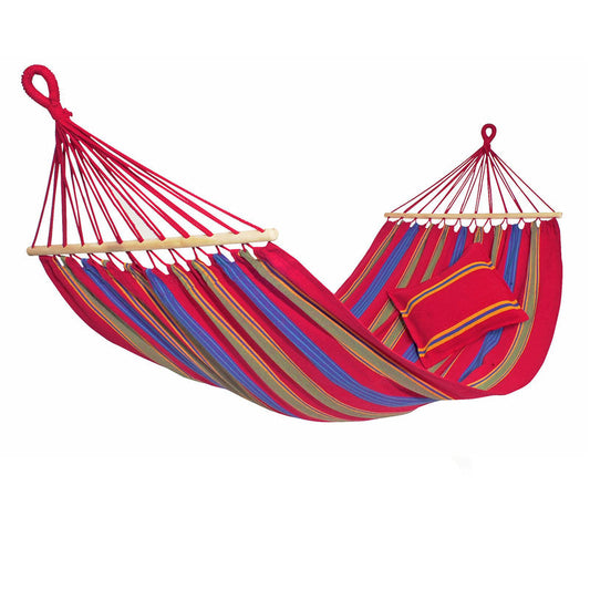 The vibrant Aruba Cayenne Hammock by Amazonas features bold red, blue, green, and yellow stripes. It comes with a coordinating striped pillow and is fully extended to display its wooden support bars and durable weatherproof red ropes for hanging.