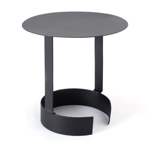 The BonFeu Raincap by Bonfeu is a modern, minimalist black metal side table featuring a round top. It showcases three vertical supports linking the top to a circular base with an open section, reminiscent of the sleek style found in BonFeu fireplaces. This piece exudes an industrial look that is ideal for contemporary spaces.