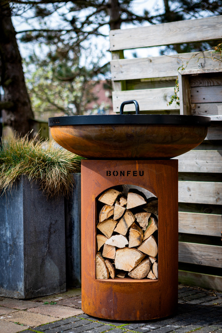 Bonfeu BonBiza Open.-Fire Bowl-Bonfeu-The BonBiza Open is an outdoor cooking instrument from BonFeu. It is like a large barbecue but for plancha baking. The BonBiza Open is one of our newer products and the showpiece of our entire collection. It is also by far the biggest product of the entire BonFeu collection. Unlike the regular BonBiza, the BonBiza Open has convenient wood storage in its base. So the BonBiza Open is the perfect piece to let you cook while enjoying a warm fire. The BonBiza Open Rust is ma