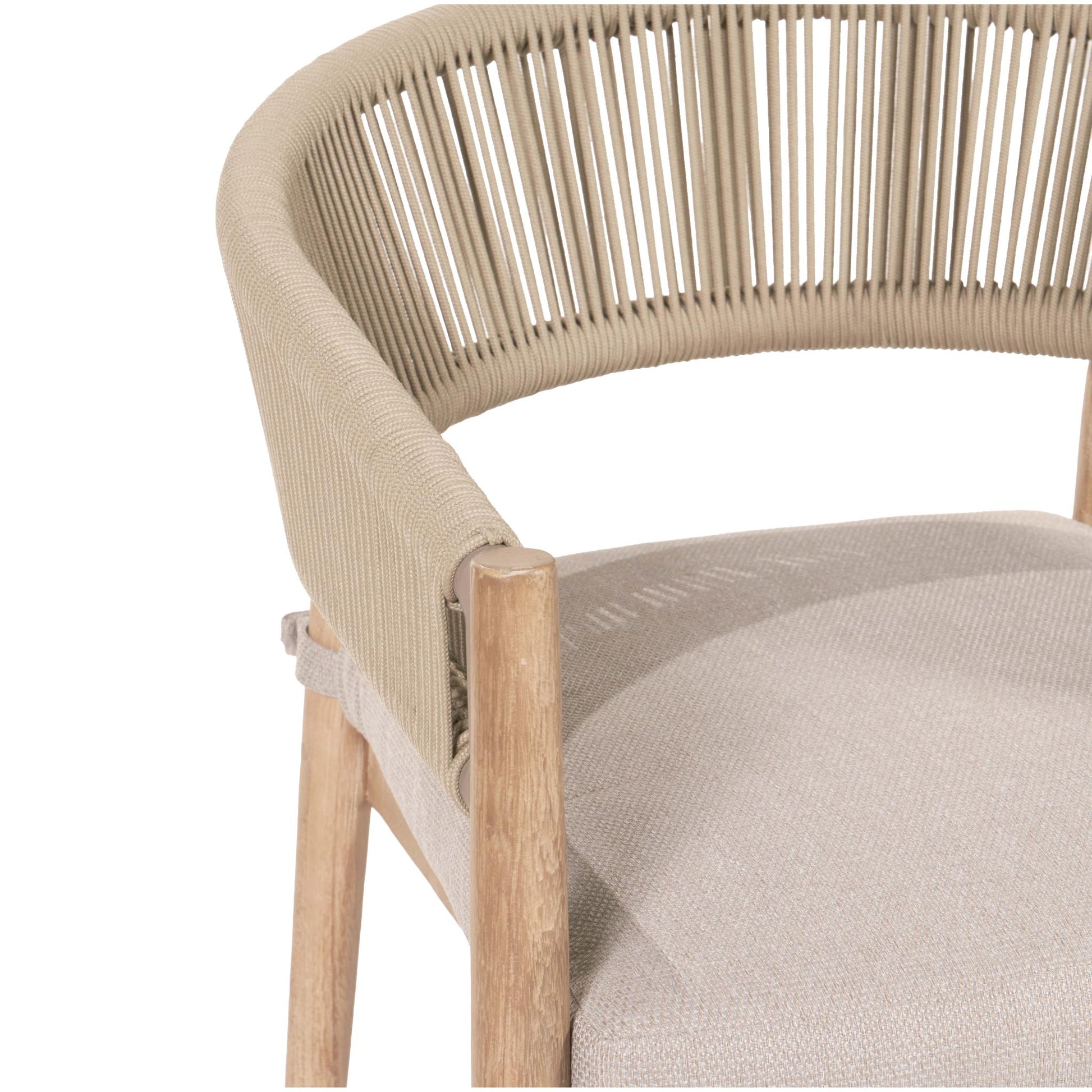 Here is a revised version of the sentence using the specified product data:

A detailed view of a Pacific Lifestyle chair featuring a beige woven rope backrest and a light acacia wood frame, crafted by hand in Vietnam. The seat is upholstered in beige fabric, making it an ideal fit for the Denver Sage Green 6 Seater Dining Set with its minimalist and contemporary design for outdoor living.