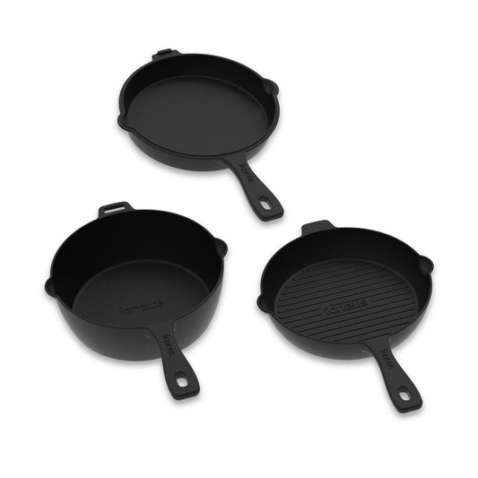 The Igneus 3 Part Cast Iron Pan Set, displayed against a white background, includes a deep skillet, a shallow frying pan, and a grill pan. This versatile cookware from Igneus features sturdy handles with small holes for hanging, making them perfect companions for any kitchen or wood-fired oven adventures.