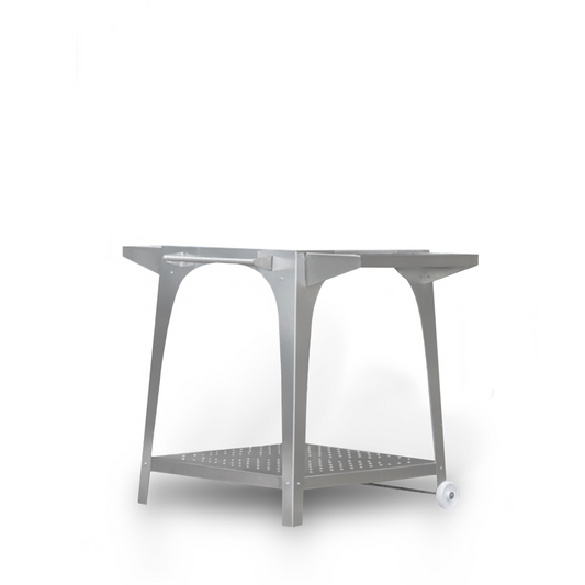 The Igneus Pizza Oven Stand is a sleek, modern piece crafted from marine-grade stainless steel, featuring an optional perforated shelf and two wheels on one side, perfect for enhancing any outdoor cooking space.