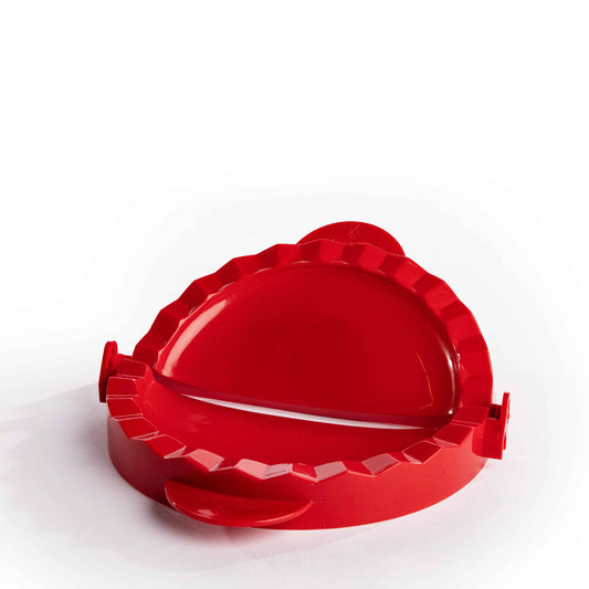 A Large Calzone Press by Alfresco Chef in red plastic is set against a white background. The open press highlights its ridged edges, expertly designed for sealing dough, making it ideal for crafting Italian classics and showcasing your culinary creativity.