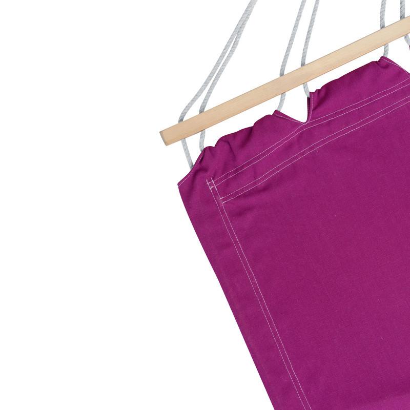 A Miami Berry Hammock from Amazonas, in a vibrant purple hue, is suspended by white cords from a wooden rod. It is showcased against a plain white background, highlighting the craftsmanship of the stitching and drawstring features.