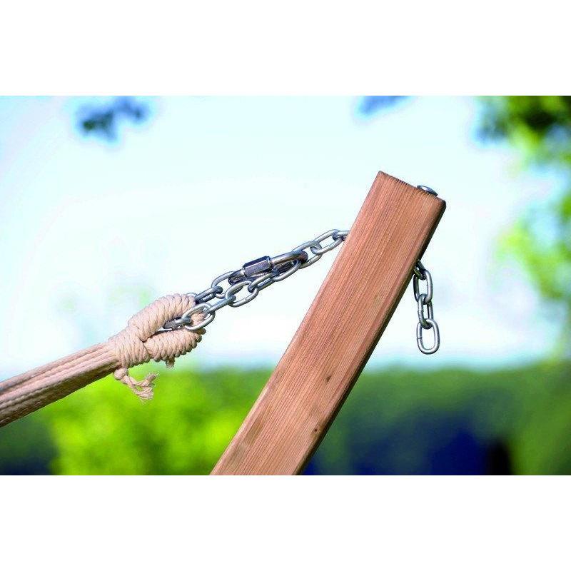 Close-up of the Star Hammock Set by Amazonas, featuring a weatherproof wooden stand with a metal chain and rope. This elegant garden feature is set against a blurred background of green trees and a clear sky, creating an oasis of relaxation.