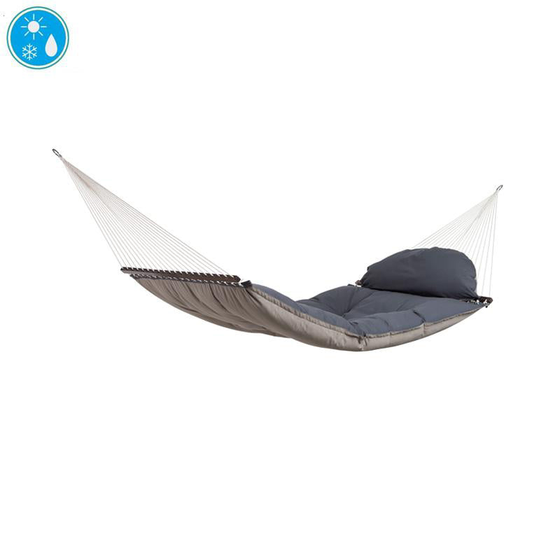 An image displays The Fat Hammock - Reversible by Amazonas, showcasing its comfortable gray padding and built-in pillow, ideal for those seeking luxury. Set against a plain white background, the hammock features water-repellent fabric designed to endure different weather conditions. A small blue icon in the corner illustrates symbols of sun, snowflake, and water drop.