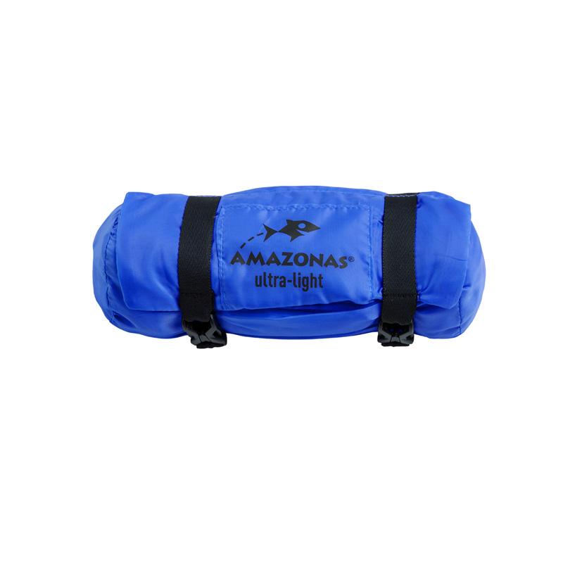 A compact blue Amazonas Travel Hammock Set, crafted from durable ripstop nylon, is rolled up and secured with two black straps. Perfect for outdoor enthusiasts, the logo features a stylized fish design.